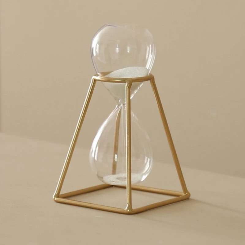 Pompa Sabbia con Cornice Dorata Clessidra con cornice dorata, oggetto decorativo scientifico, perfetta per arredamento da studio o ufficio, simbolo di tempo e precisione.