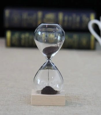 Clessidra decorativa con sabbia nera, simbolo di tempo e pazienza, perfetta come oggetto decorativo scientifico o da scrivania.