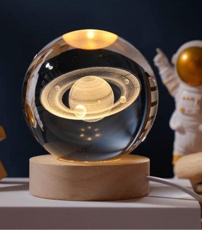 Modello di sistema solare in sfera di vetro con pianeti e anelli, decorazione scientifica elegante e educativa per ambienti domestici o uffici.