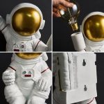 Modello di astronauta in miniatura con casco dorato e tuta bianca, perfetto come decorazione scientifica o oggetto da collezione.