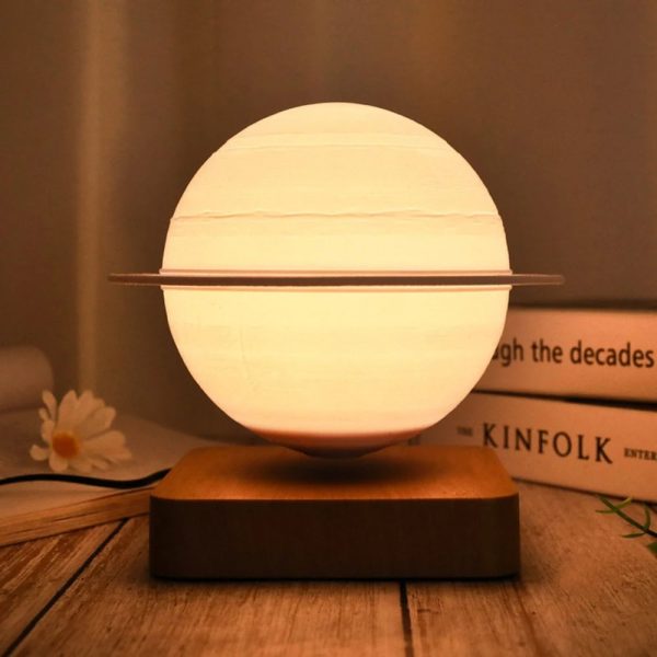 Lampada decorativa ispirata a un modello planetario, con sfera luminosa e anello orbitale, perfetta per ambienti moderni e studi scientifici.