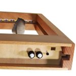 Oggetto scientifico in scatola di legno con componenti elettronici e sensore, perfetto come decorazione o strumento educativo.