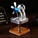 Modello in miniatura di un generatore di Van de Graaff con rotore e base in legno, perfetto come decorazione scientifica.