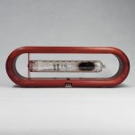 Orologio a clessidra con contenitore di vetro e struttura in legno rosso, perfetto come decorazione scientifica elegante e originale.