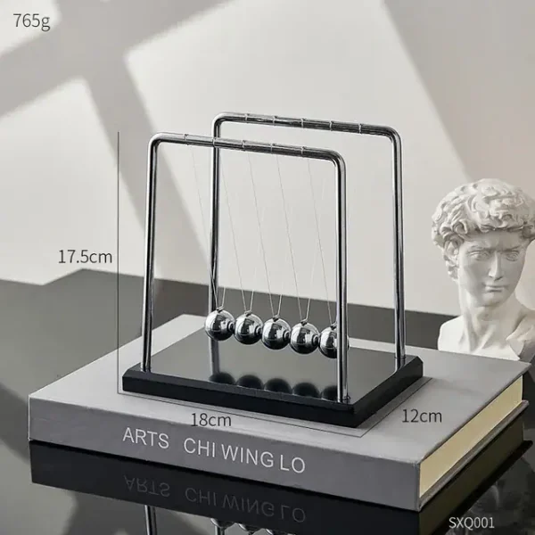 Pendolo di Newton in metallo e vetro, perfetto come decorazione scientifica per studi e uffici, con sferette oscillanti e design elegante.