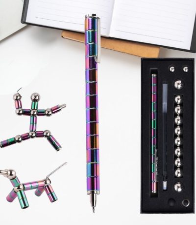 Set di penne e sfere scientifiche colorate in metallo, ideali come decorazioni o strumenti educativi, con scatola di presentazione e notebook aperto sullo sfondo.