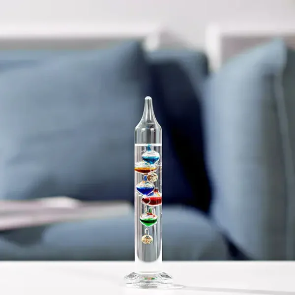 Vaso con sfere colorate di Newton, decorazione scientifica elegante e educativa, perfetta per appassionati di scienza e arredamento originale.