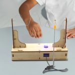 Esperimento di elettrostatica con bobina e filo conduttore, dimostrando la distribuzione di carica e le proprietà elettriche.