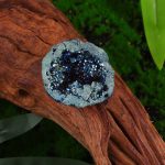Geode con cristalli blu su tronco di legno, decorazione scientifica naturale, oggetto decorativo per appassionati di scienza e mineralogia.