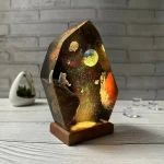 Oggetto decorativo con tema spaziale, luci LED e effetto galassia, ideale per appassionati di astronomia e decorazioni originali.