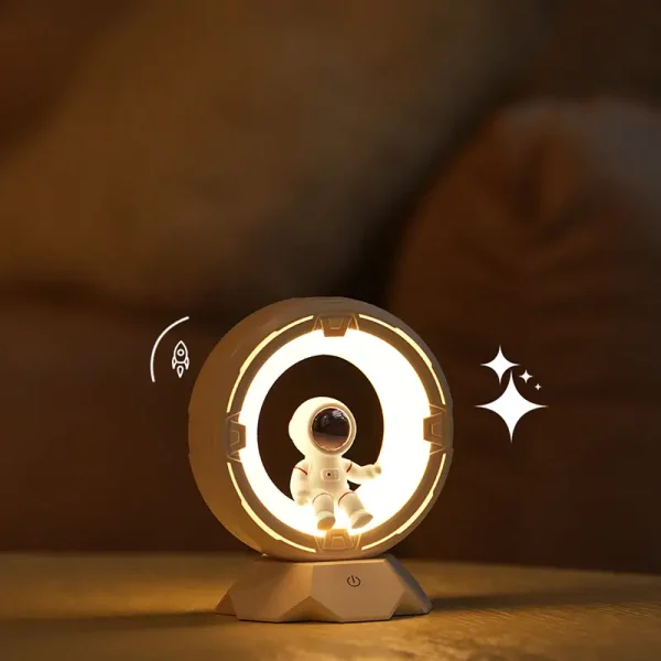 Lampada da tavolo a tema spaziale con astronauta e anello luminoso, perfetta come decorazione scientifica e oggetto di design innovativo.