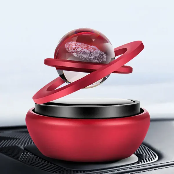 Pianeta decorativo con anelli rossi e sfera trasparente, ispirato ai corpi celesti, perfetto come oggetto di design scientifico e decorativo.