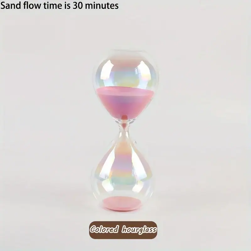 Ampolla di vetro colorata con sabbia rosa che scorre lentamente.