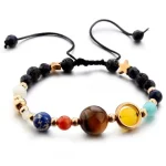 Braccialetto decorativo con perle colorate e dettagli a forma di stella e sfera, ispirato a oggetti scientifici, perfetto come accessorio originale e unico.