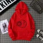 Maglione con cappuccio rosso e stampa di sole e luna, ideale per uno stile casual e originale.