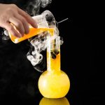 Esperimento scientifico con beuta e vapori colorati, rappresentando un classico esperimento di chimica con reazioni visive.