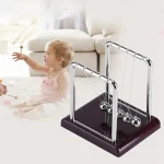 Péndolo di Newton per bambini, gioco scientifico educativo con sfere metalliche su base in legno, stimola la curiosità e l'apprendimento della fisica.