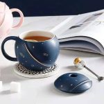 Tazza astronomica blu con decorazioni stellari, mouse coordinato e accessori scientifici, ideale per appassionati di astronomia e decorazioni a tema scientifico.