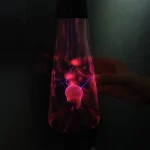 Lampada a plasma con scariche elettriche visibili, illuminata in modo suggestivo, ideale come decorazione scientifica o oggetto di studio sulla fisica dei plasma.