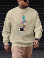 Felpa con illustrazione di pianeti e astronauti, perfetta per gli amanti della scienza e dell'astronomia. Confortevole e alla moda, ideale per un look informale ispirato all'universo.