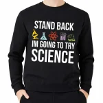 Una giacca con cappuccio nera con il testo "Stand Back, I'm Going to Try Science" e icone di laboratorio colorate, ideale per gli appassionati di scienza e di decorazione scientifica.