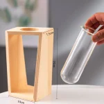 Supporto in legno e tubo di vetro per esperimenti scientifici, ideale per attività educative e dimostrative in laboratorio.